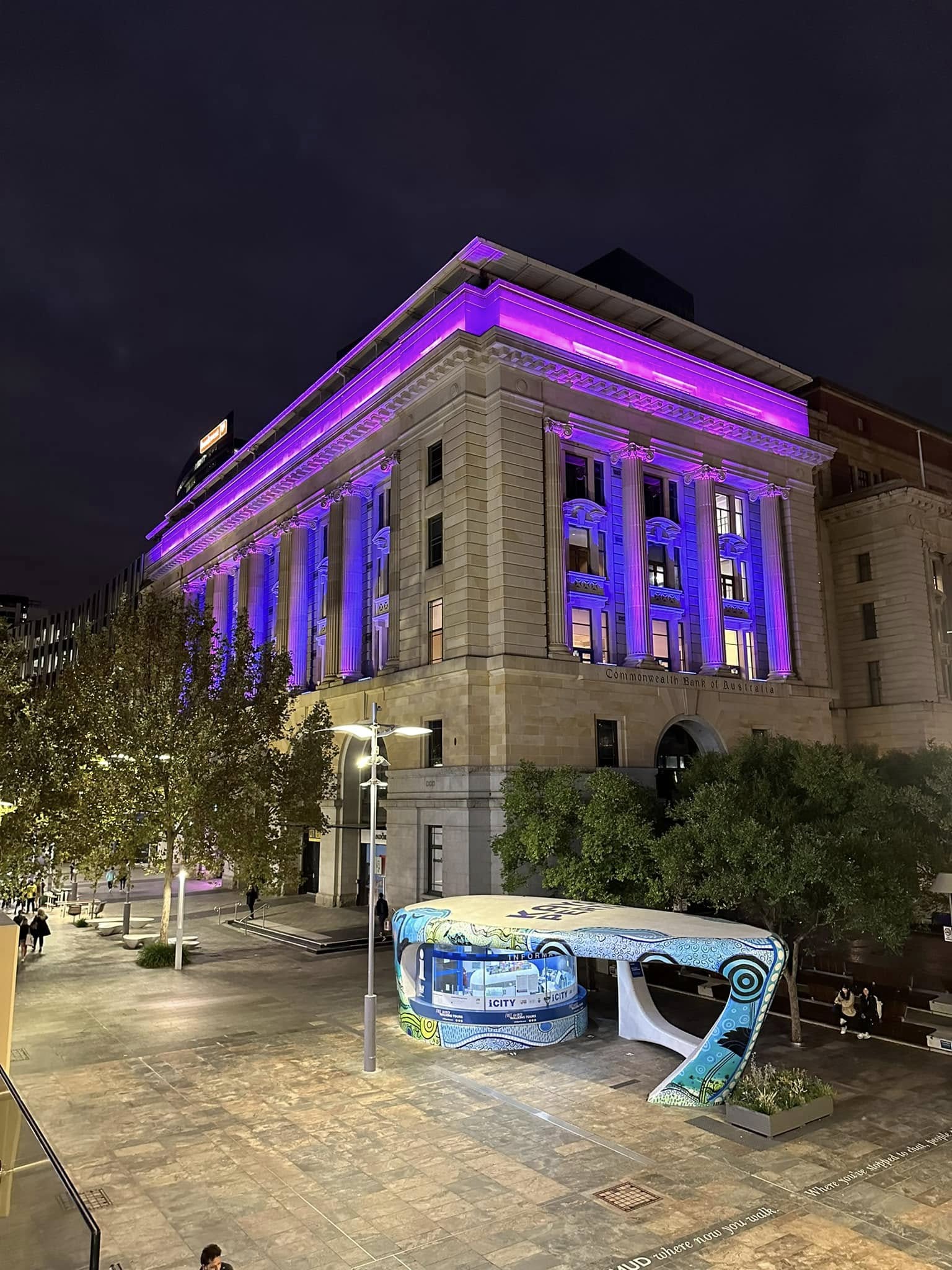 The Perth façade washed in purple, viewed from the square.