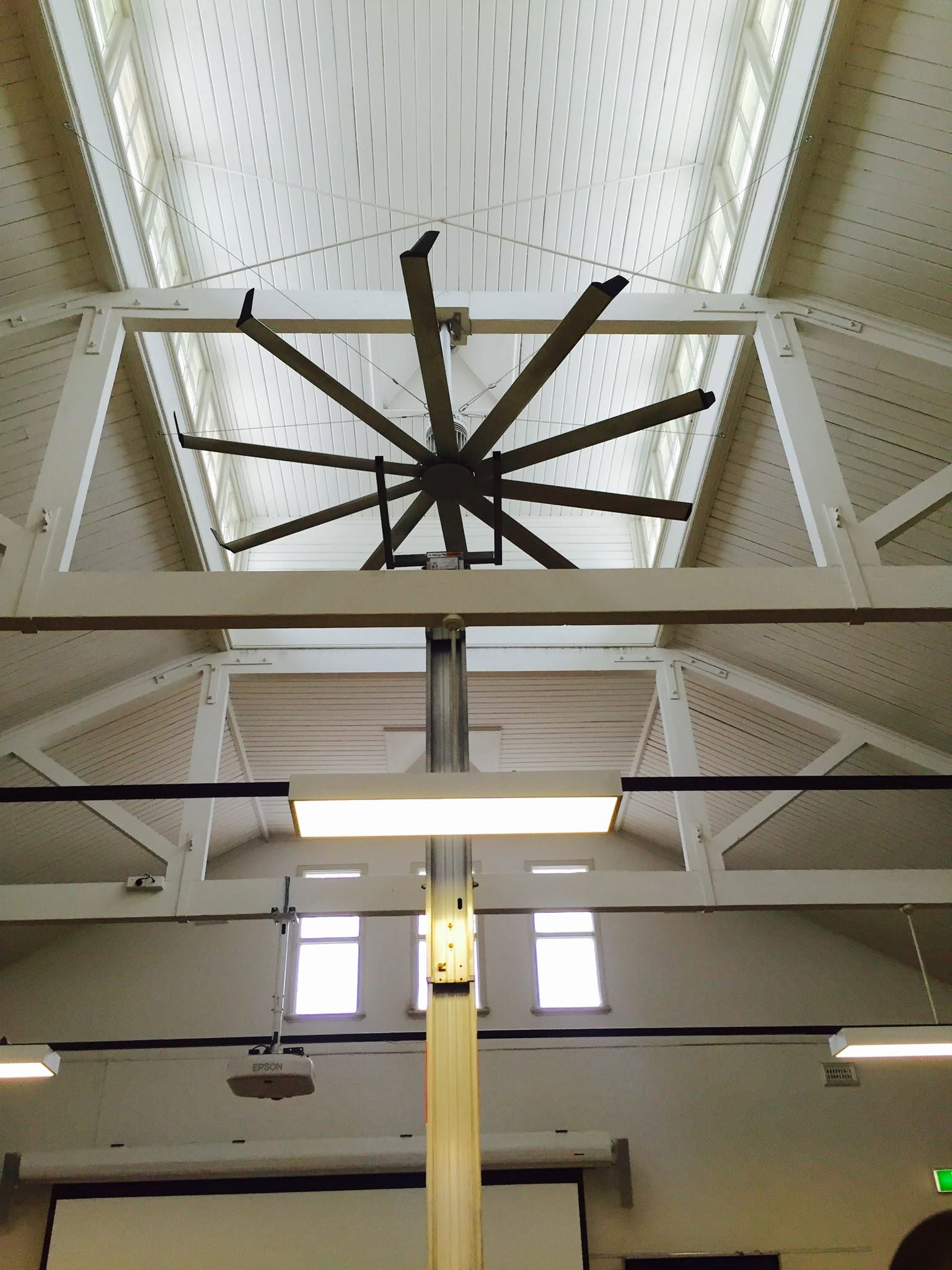 HVLS fan seen from directly below in a hall.