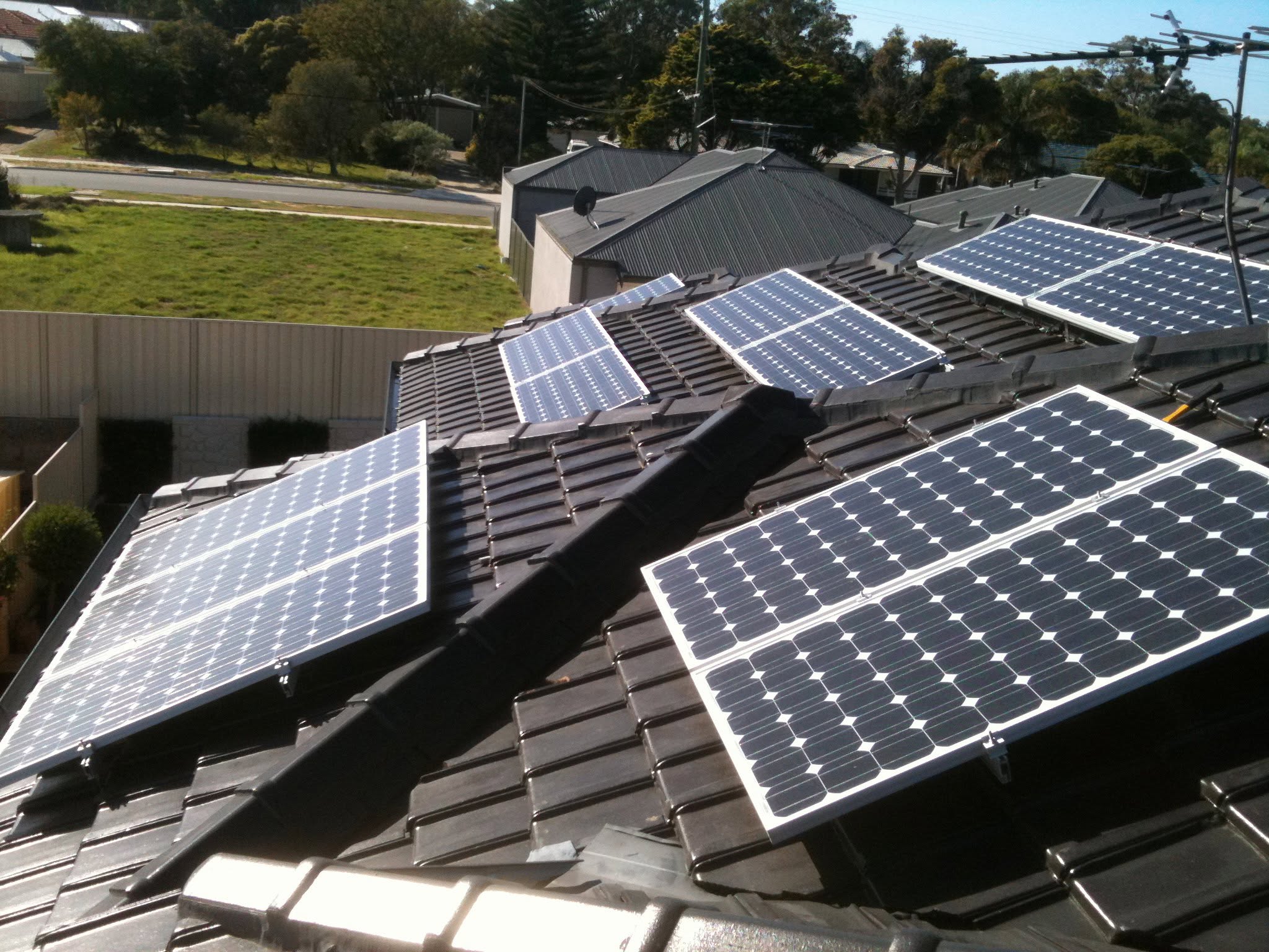 Solar panels installed across a tiled residential roof.