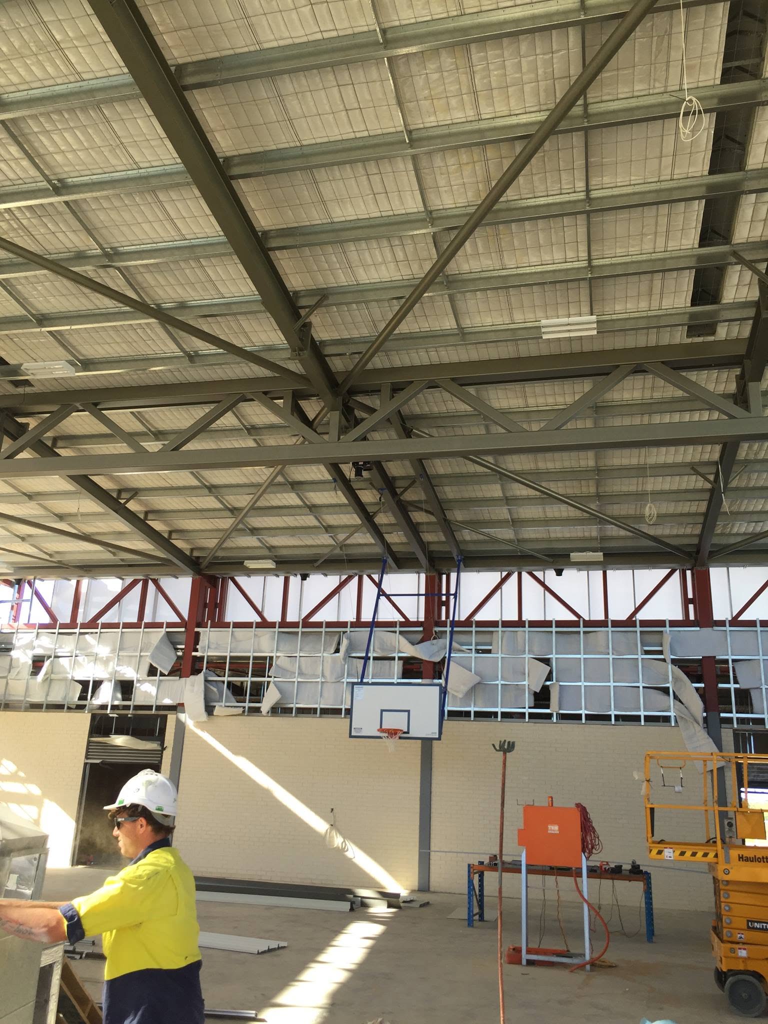Oasis electrician in hi-vis during a warehouse install.