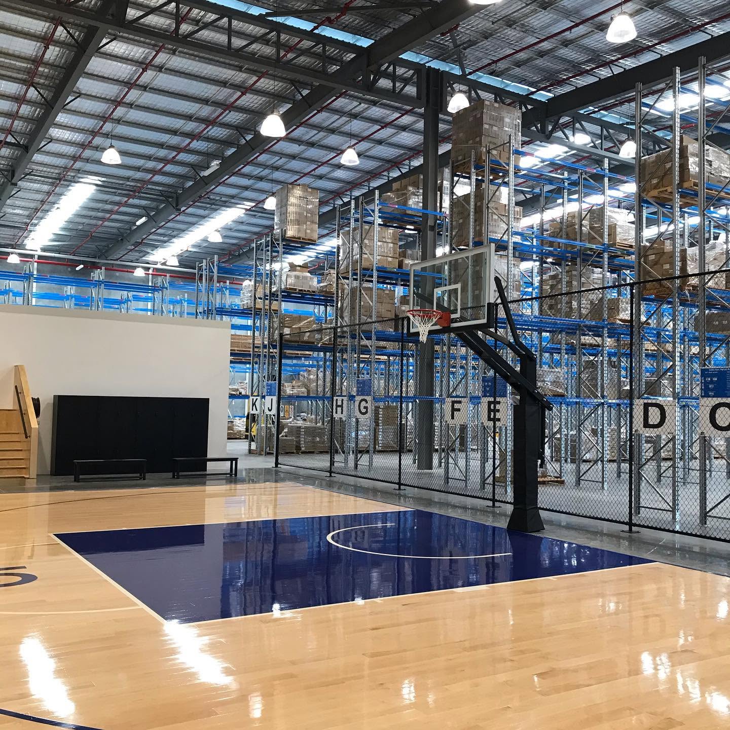 High-bay lighting above warehouse racking.